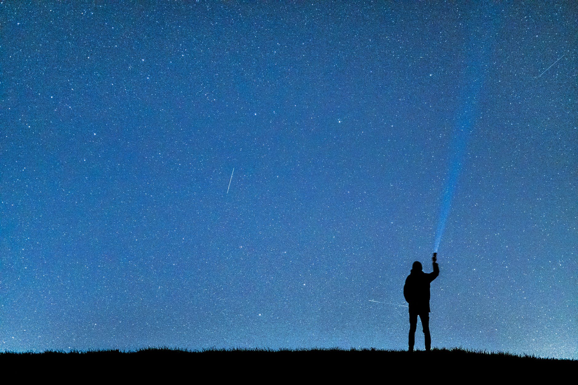 silhouette of man under blue sky during nighttime